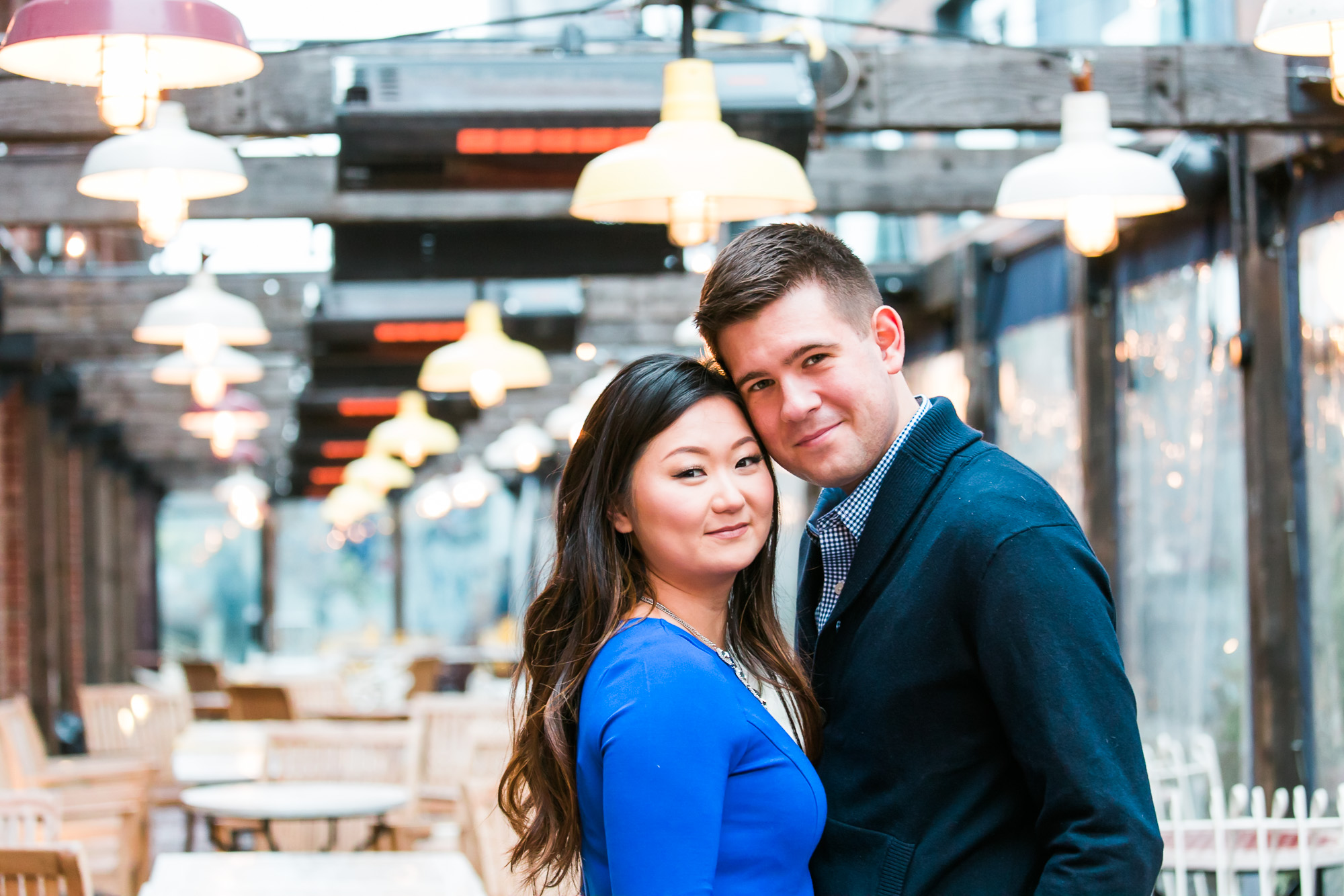 an outside photograph with the couple standing close to one other.