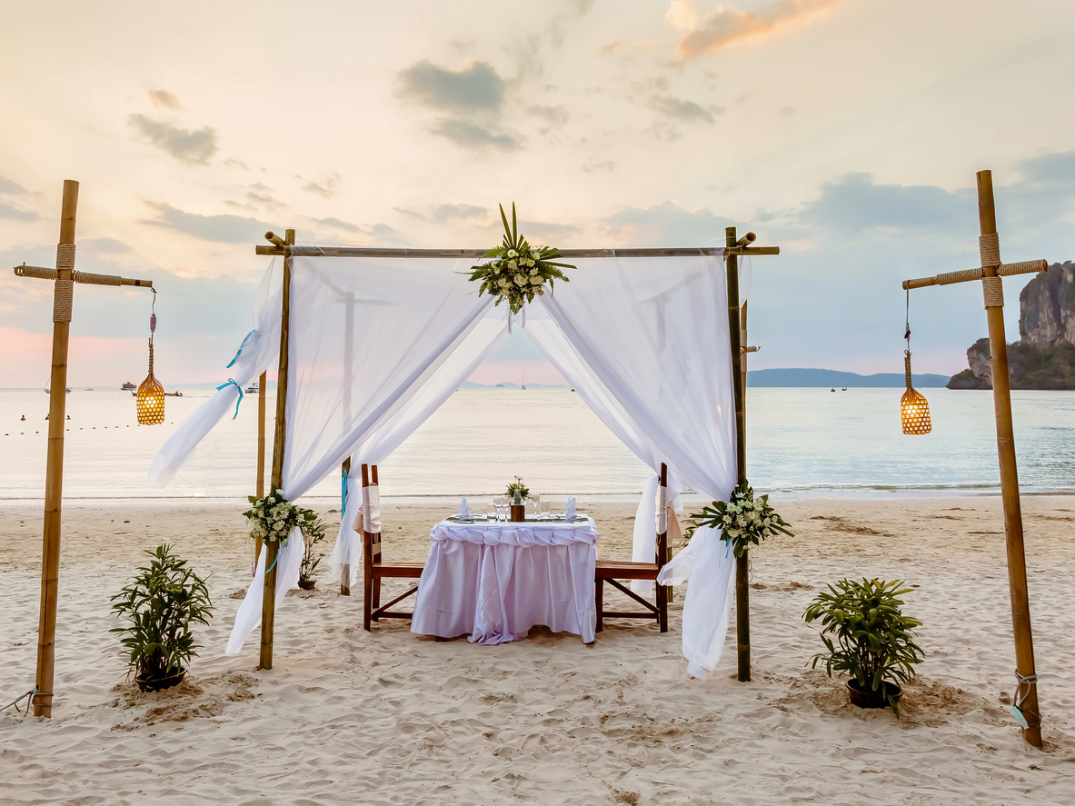 gorgeous DIY wedding altar made from a flowing white linen and accented with flowers and lights