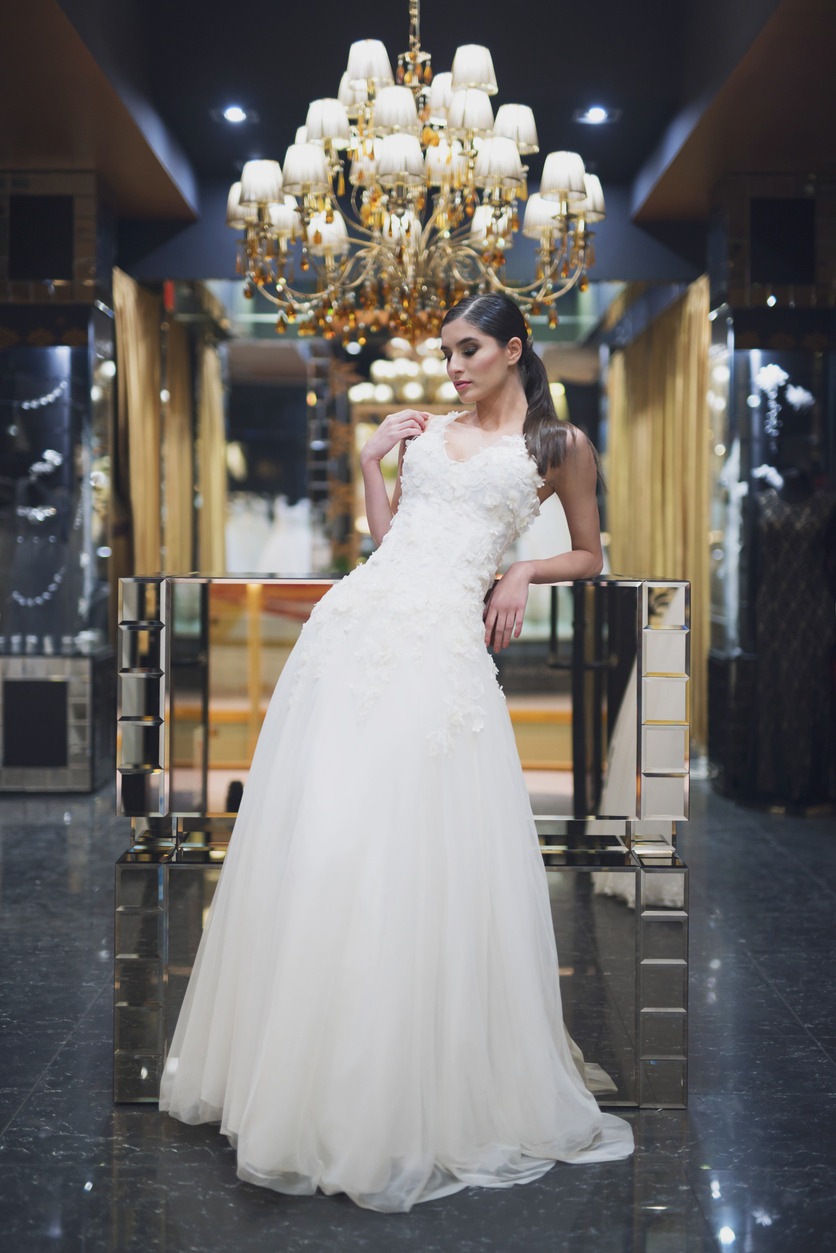 Beautiful female model posing in a wedding dress in a luxury salon