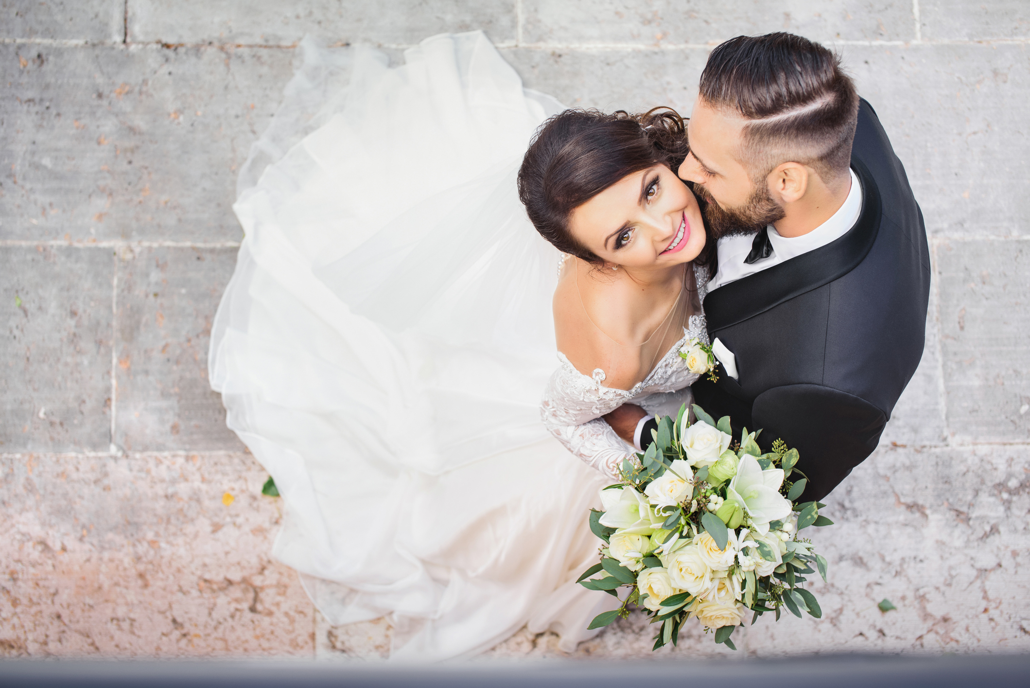 Beautiful wedding couple cuddling on their wedding day