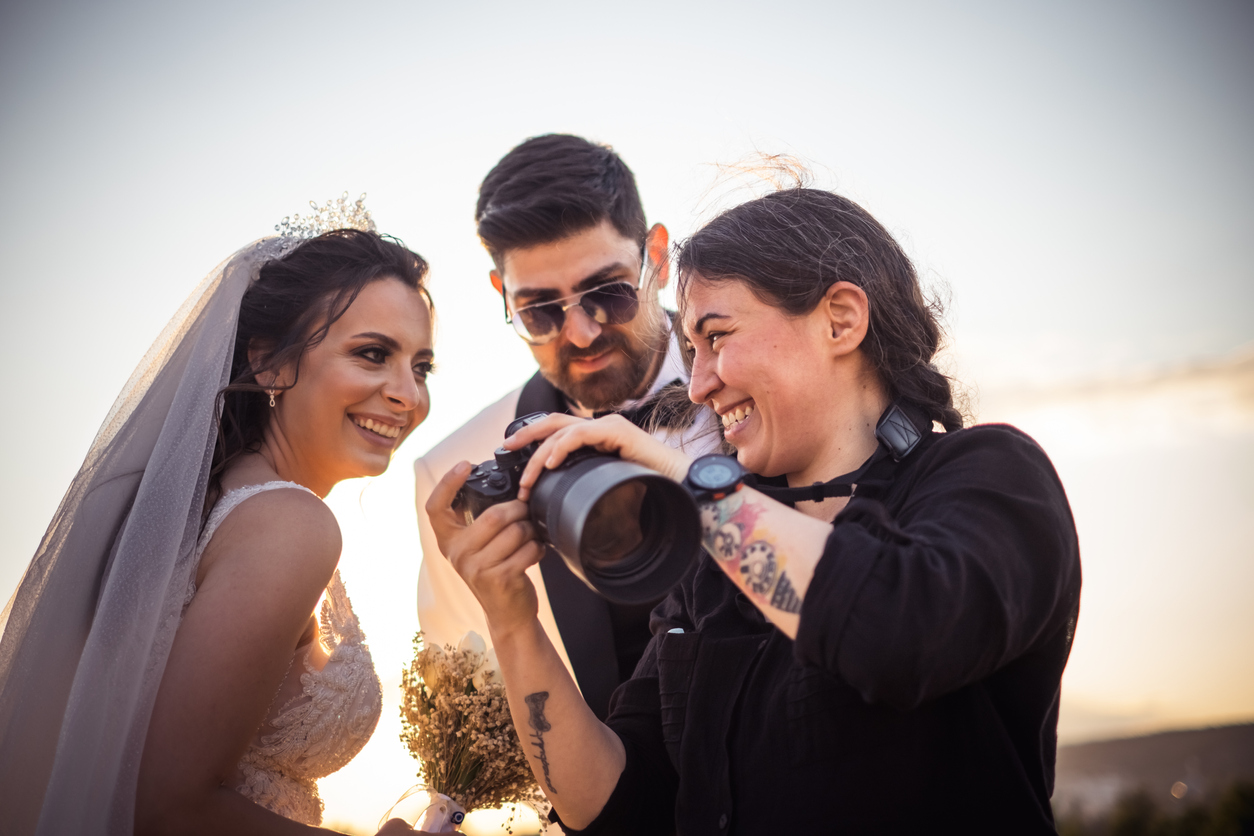 Wedding photographer with a profesional camera shooting bride and groom