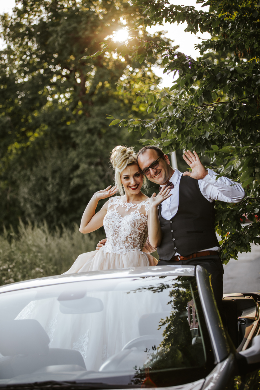 Just married young couple in convertible car