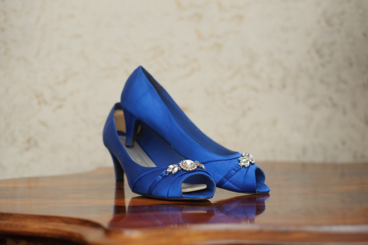 A set of beautiful blue high heels ready to be worn at a wedding.