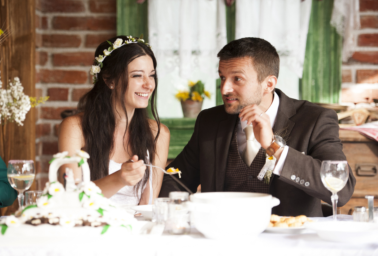 Bride and groom are eating at the wedding reception