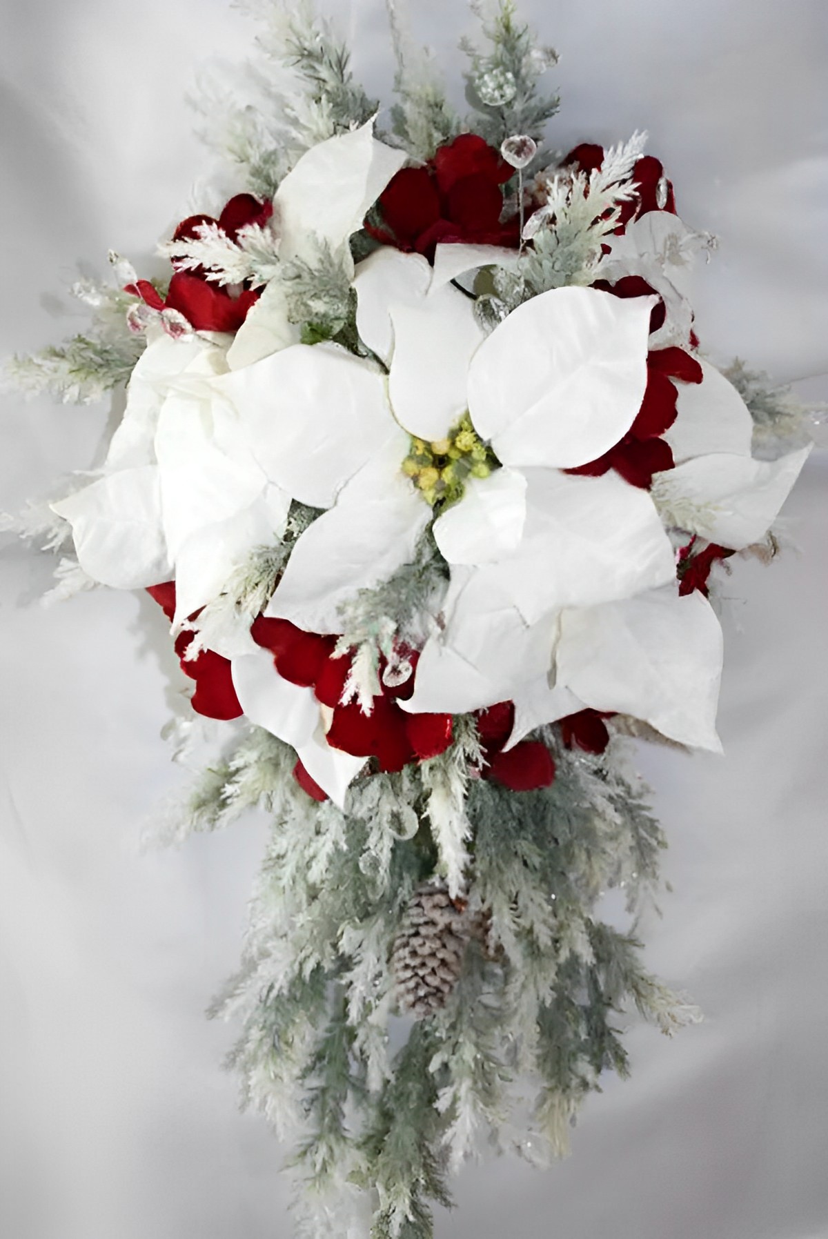 this elegant bouquet with red and white poinsettia and other embellishment is perfect for a Christmas-themed wedding.