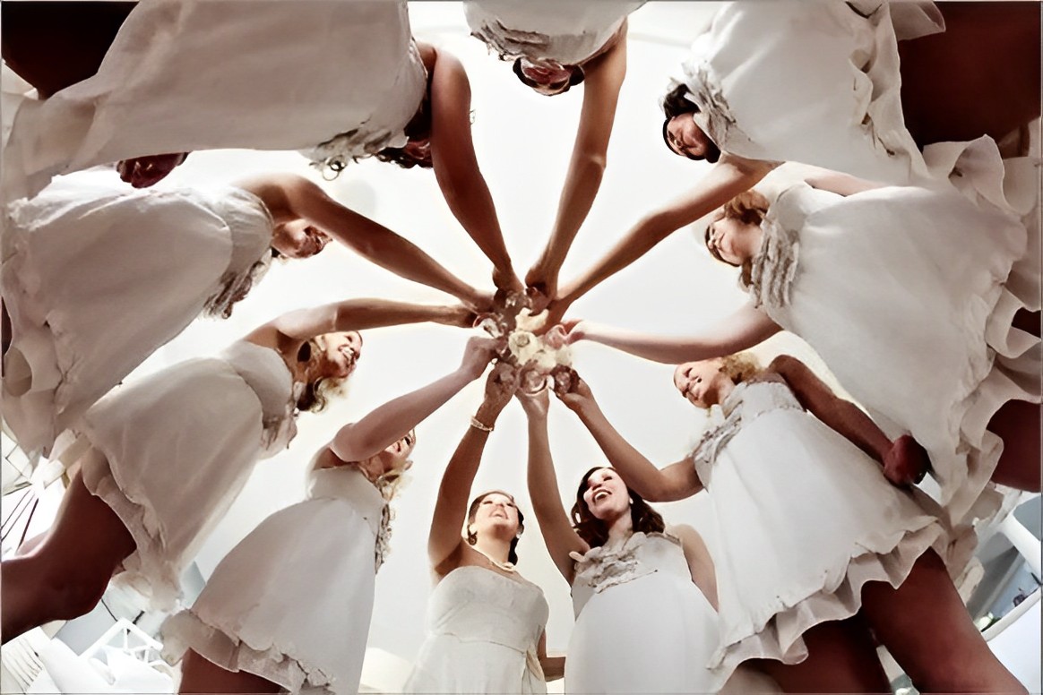 At the wedding, a one-of-a-kind photo of the bride and bridesmaids toasting with champagne.