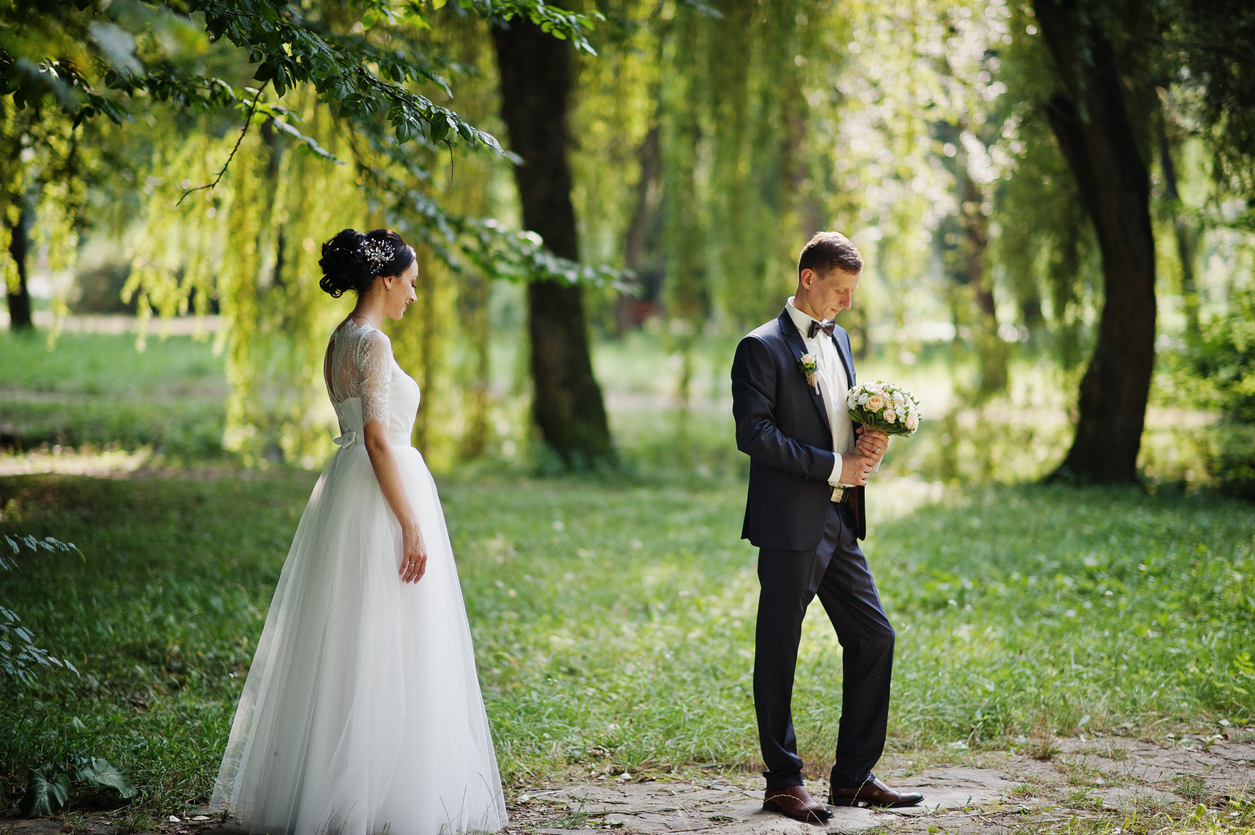 The groom waits expectantly for his first glimpse of his gorgeous wife.