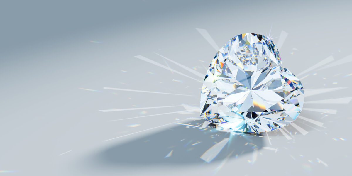 close-up heart cut diamond with caustics rays on light blue background