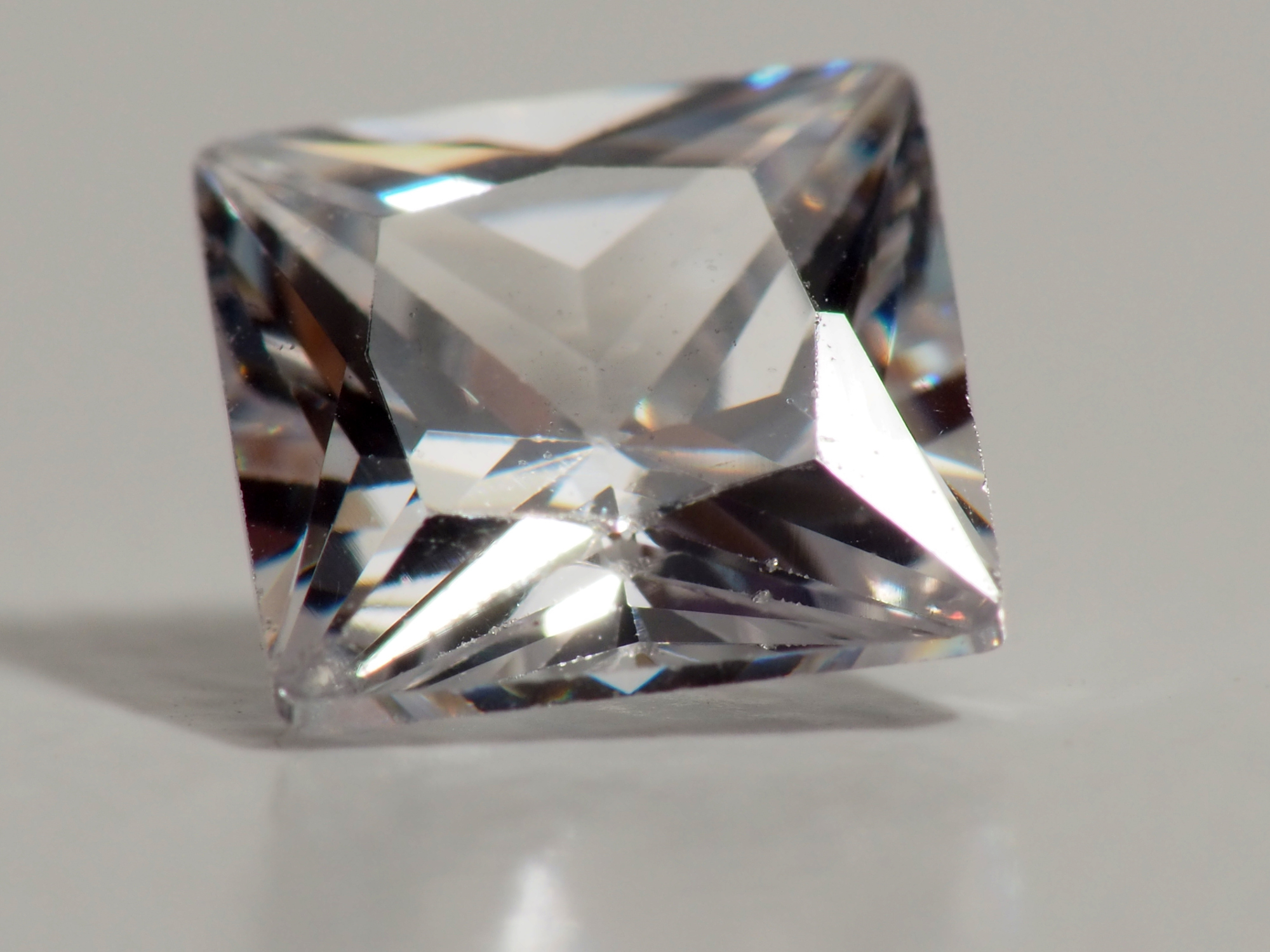 close up shoot of brilliant princess cut diamond, captured on a white isolated background