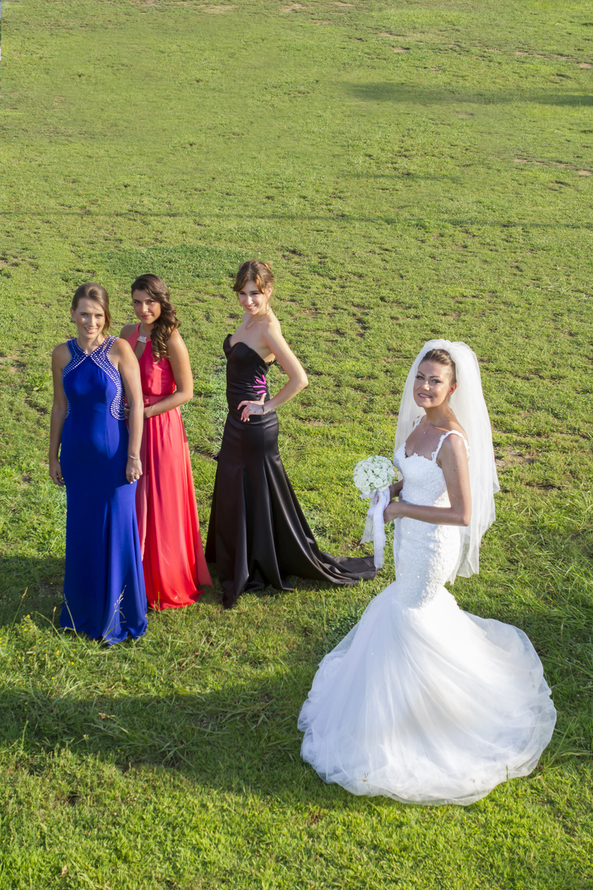 photo of bride and bridesmaids wearing mismatched dresses