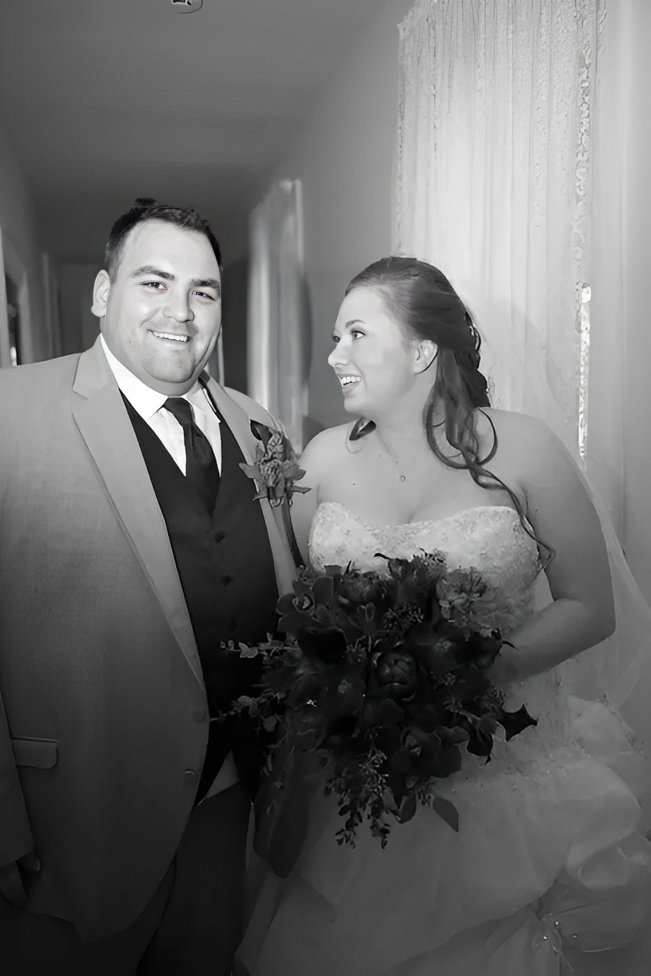 black and white photo of bride staring on the groom