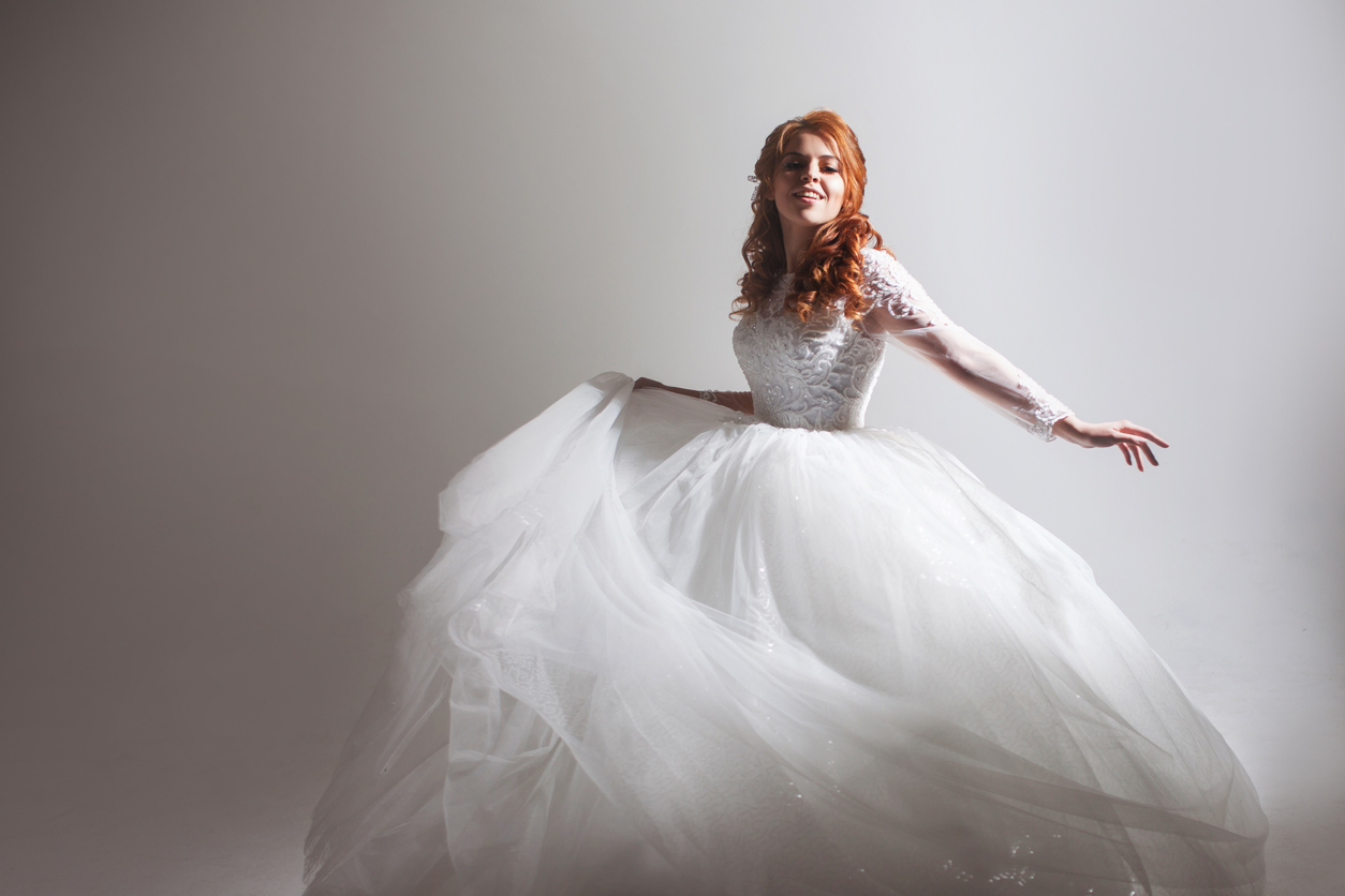 In her white ball wedding gown, the bride appears beautiful and exquisite.