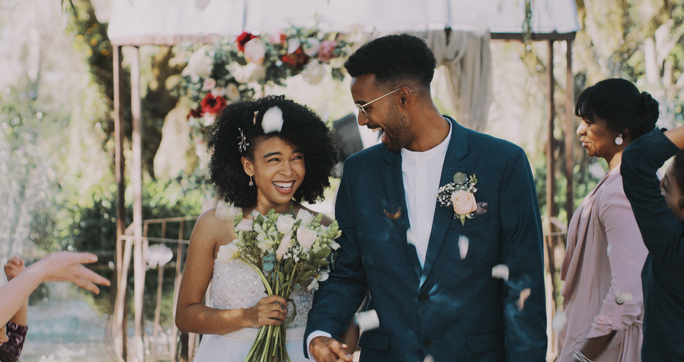 Cropped shot of a newlywed couple walking down the isle together after being announced as husband and wife