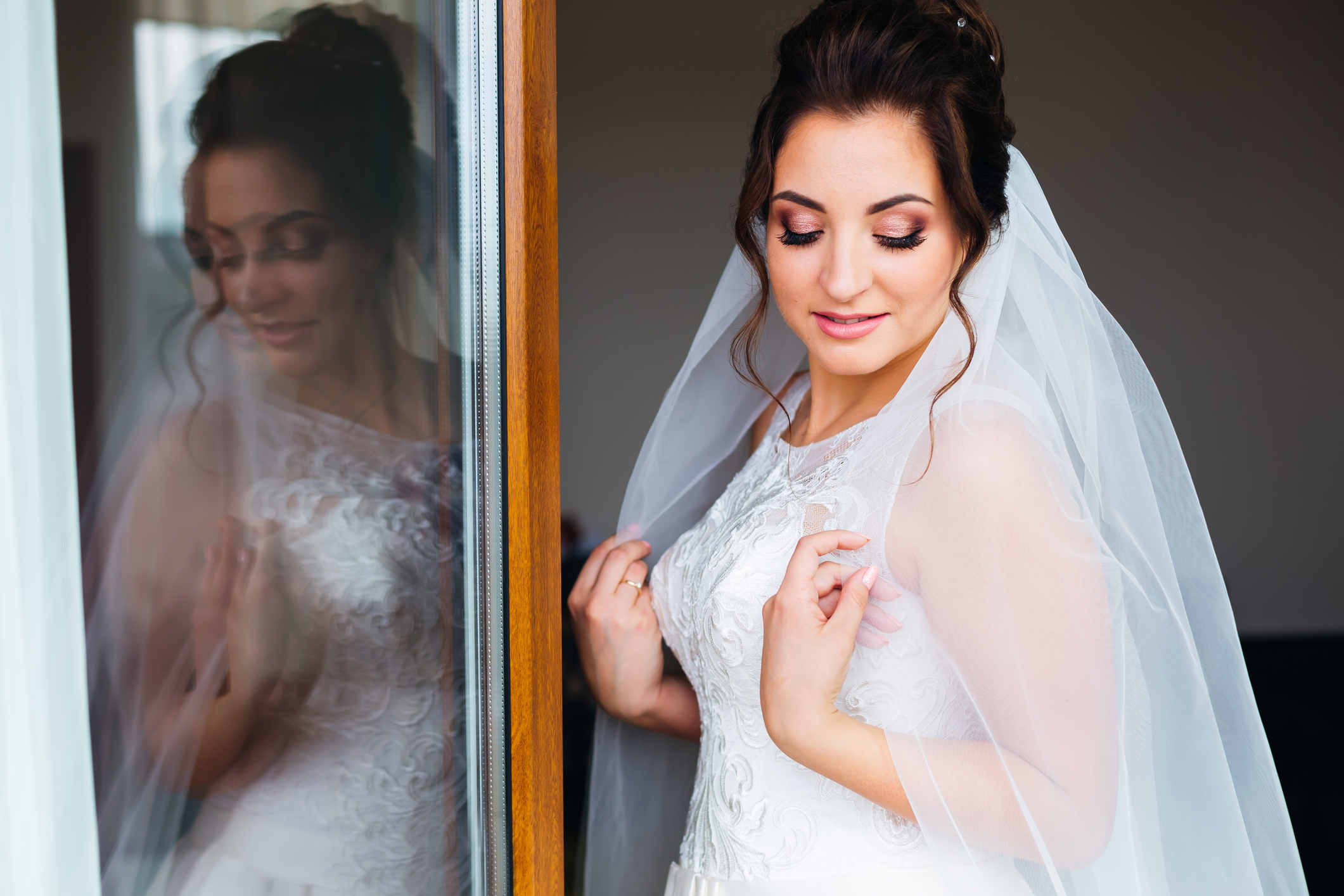 the bride closed her eyes. reflection in the window. beautiful makeup