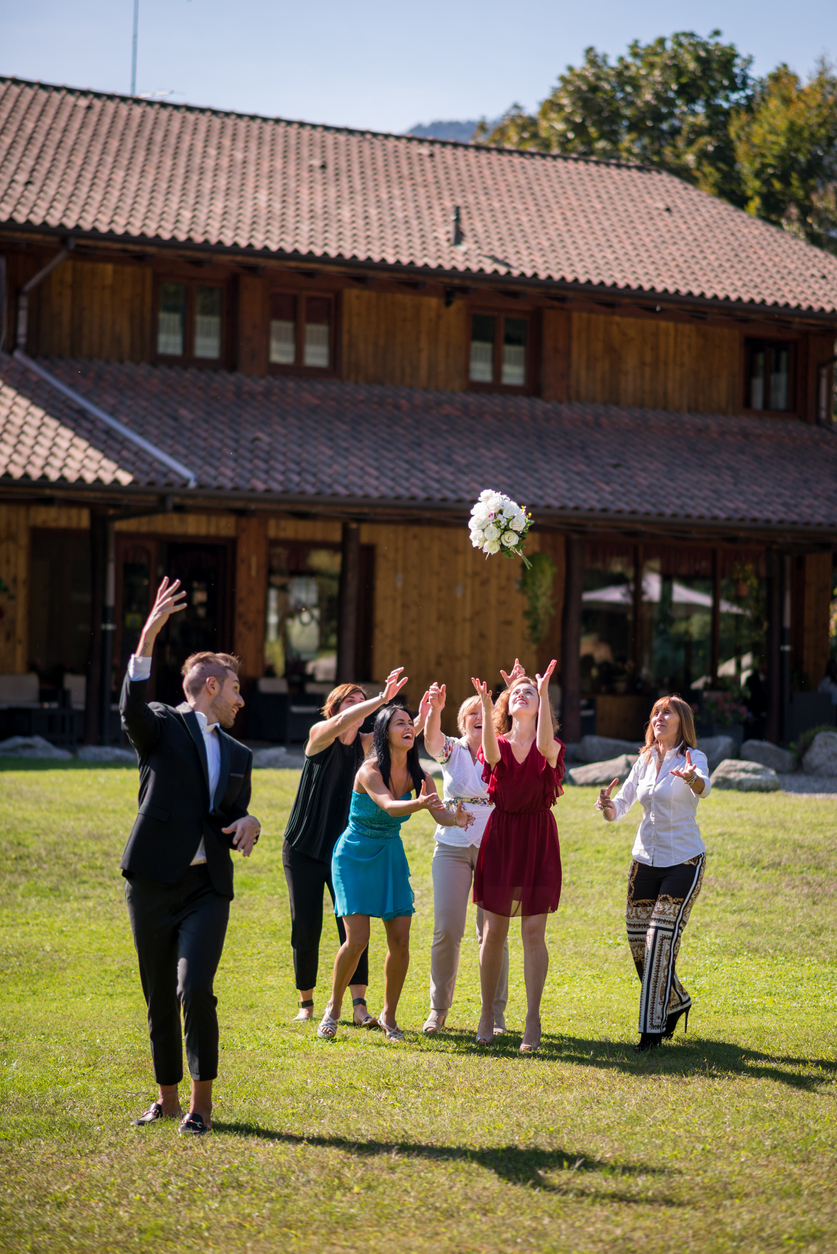 throwing of bouquet by the groom tp the bridesmaids.