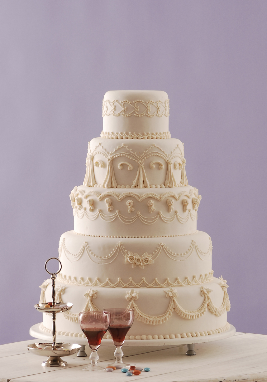 The wedding cake itself is often a large, multi-tiered confection, carefully crafted and decorated with intricate details and embellishments.