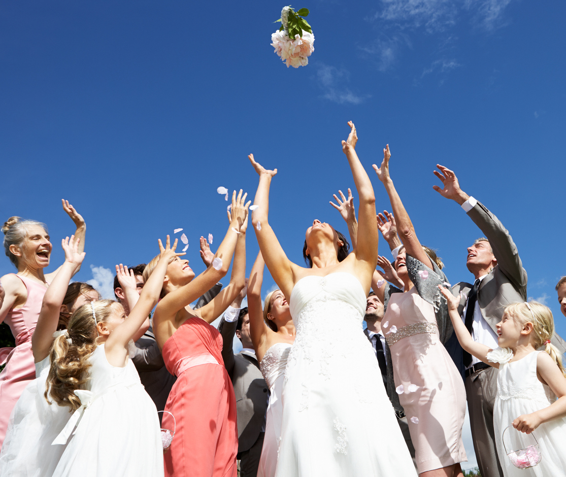 Bouquet + Garter Toss Photos from Blume Photography bride throwing bouquet outdoors for guests to catch.
