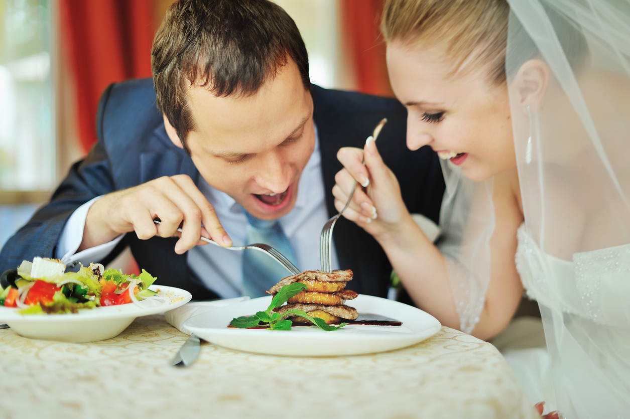 happy groom and bride together in cafe having fun. Happy newlywed couple at wedding