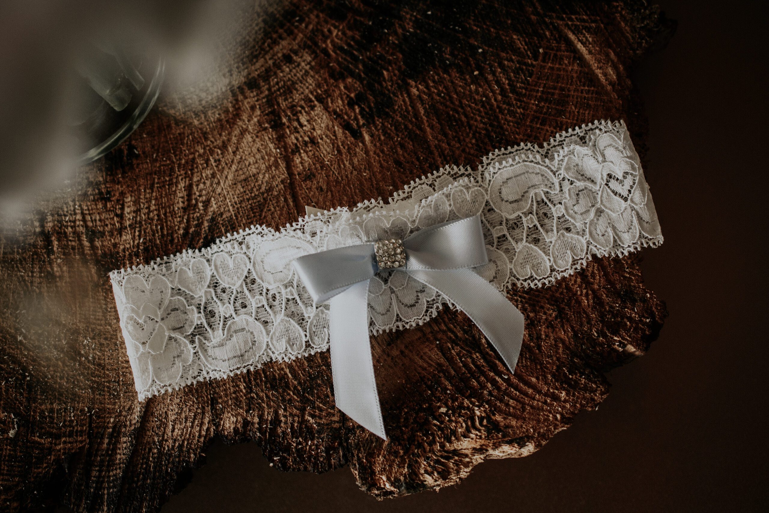 bride's lace garter belt on top of a piece of wood