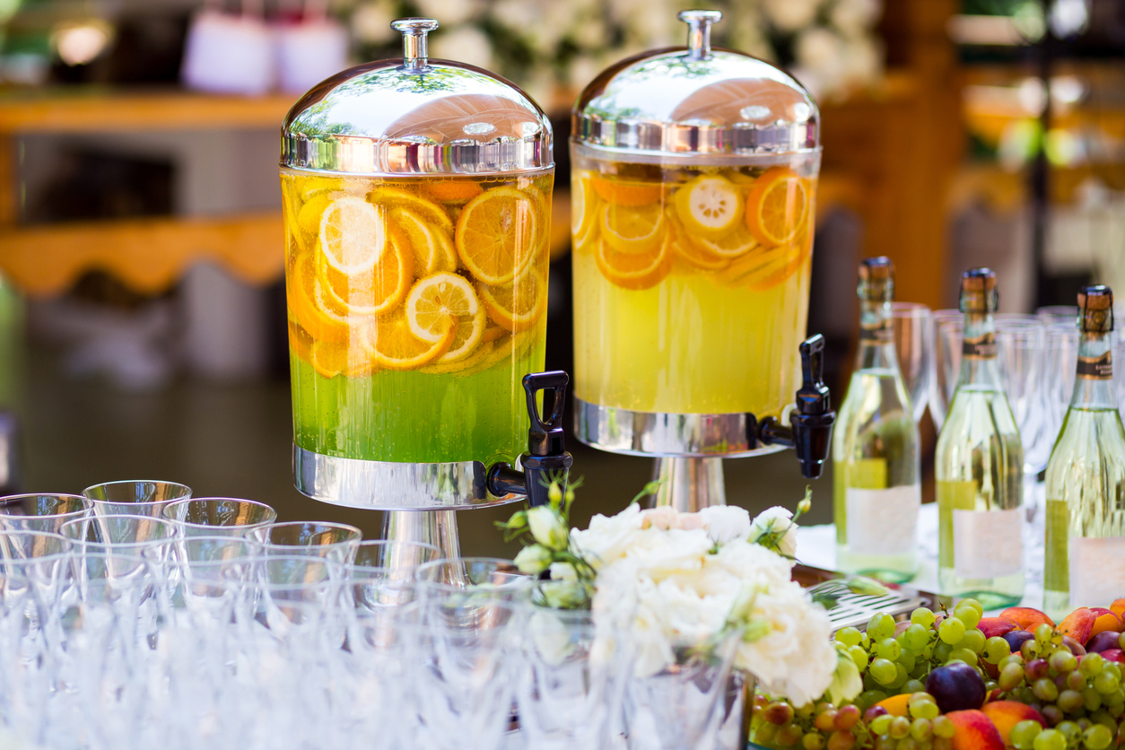 fruity lemonade, fruit refreshing drink, orange juice, catering, glasses for wine or champagne, ,lemonade in glass barrels for wedding drinking station.