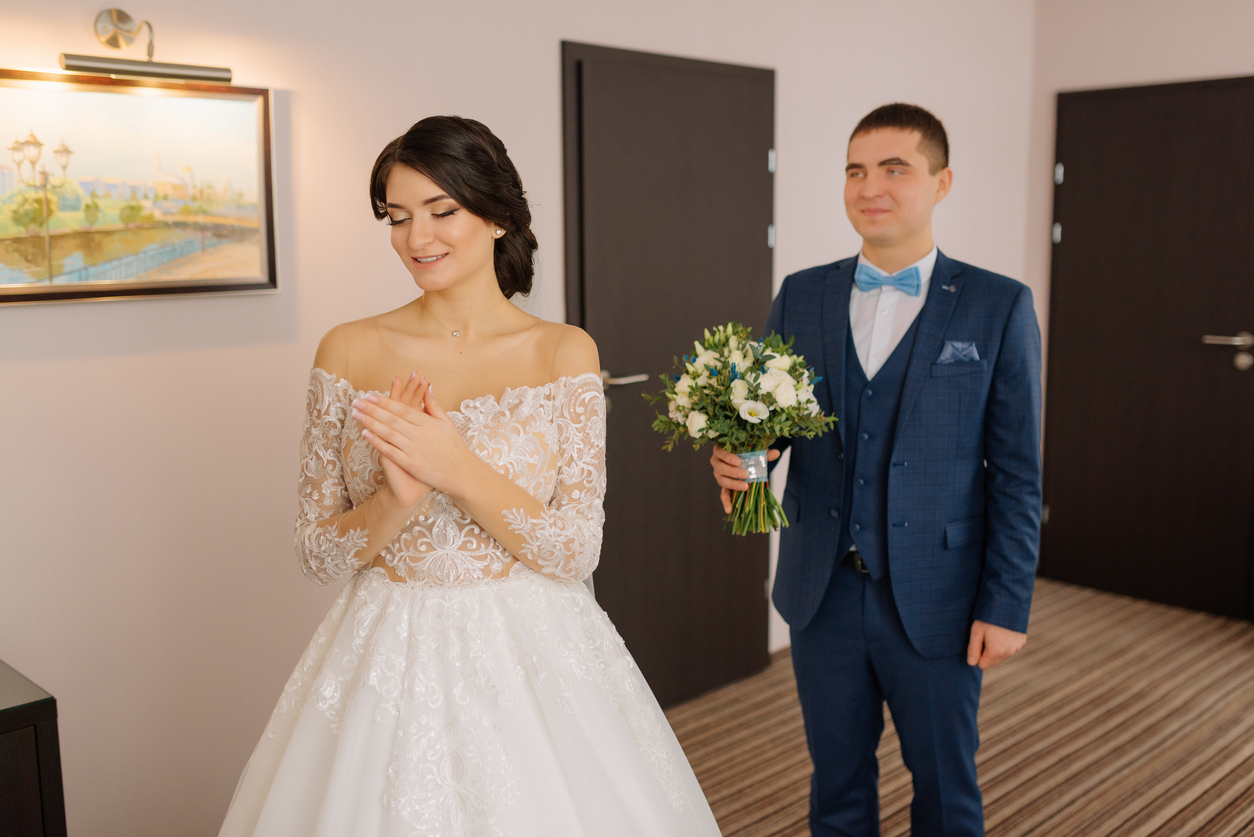 the groom holding the bouquet of the bride on their first-look before the ceremony.