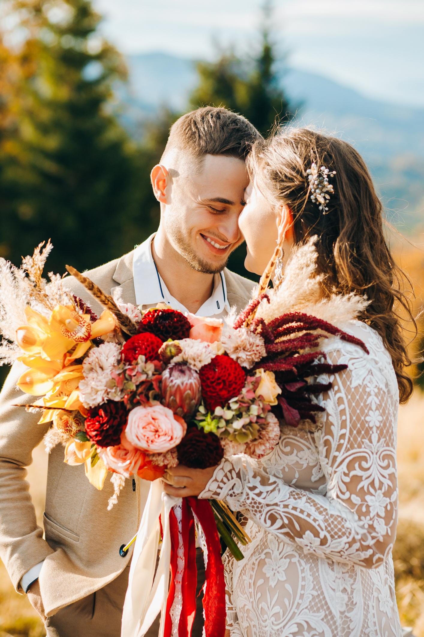 Happy couple hugging under wedding arch. Fall wedding shoot.