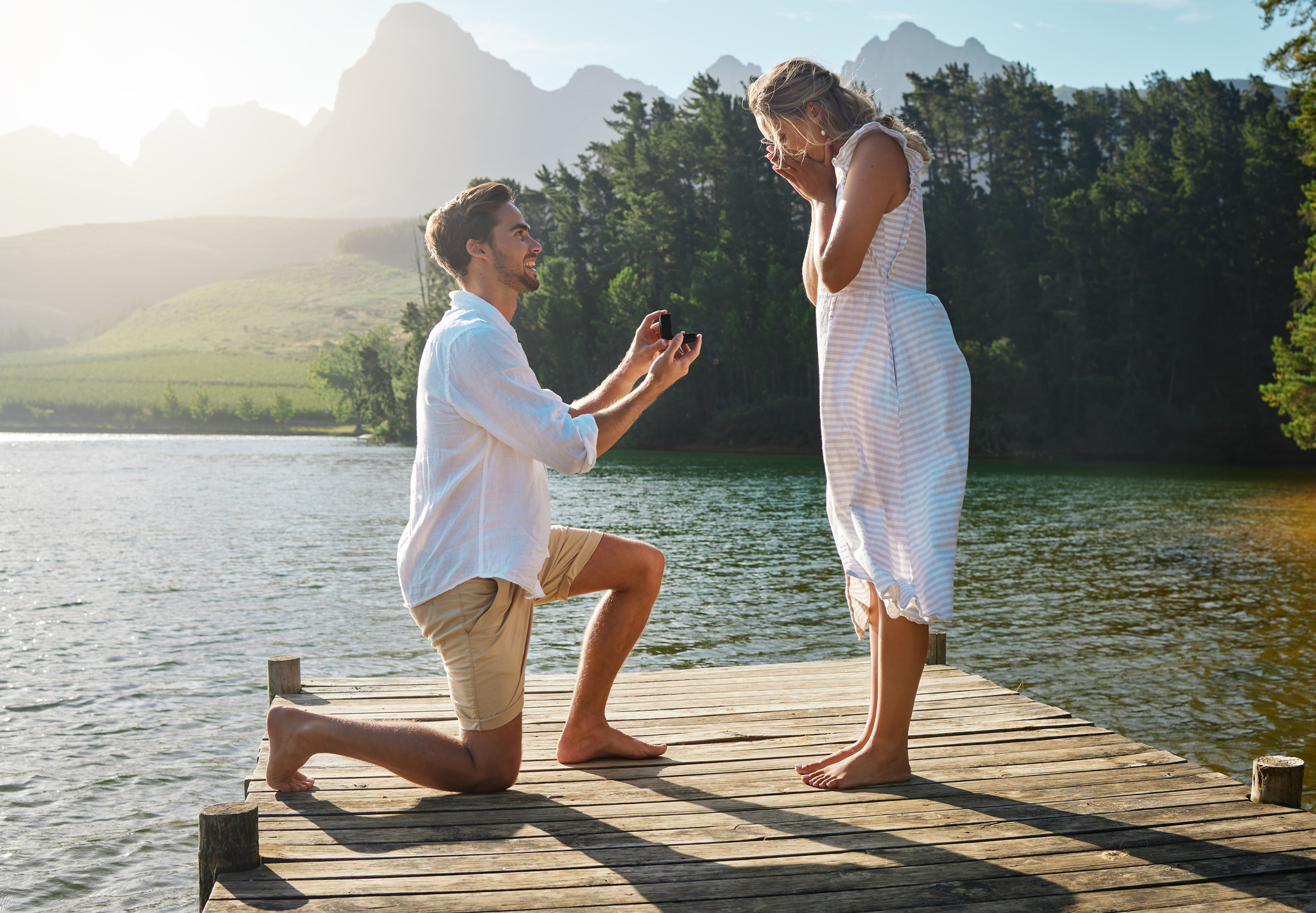 Shot of a young man proposing to his girlfriend in nature