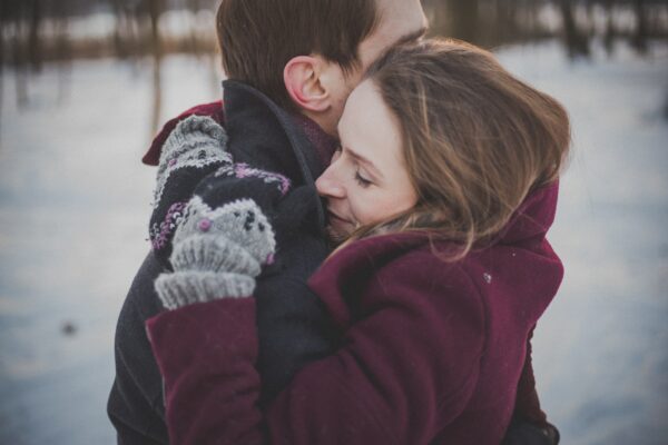 couple being photographed on a location filled with snow