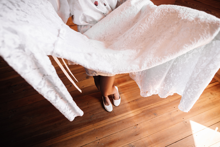 The  bride is donning white ballet flats.